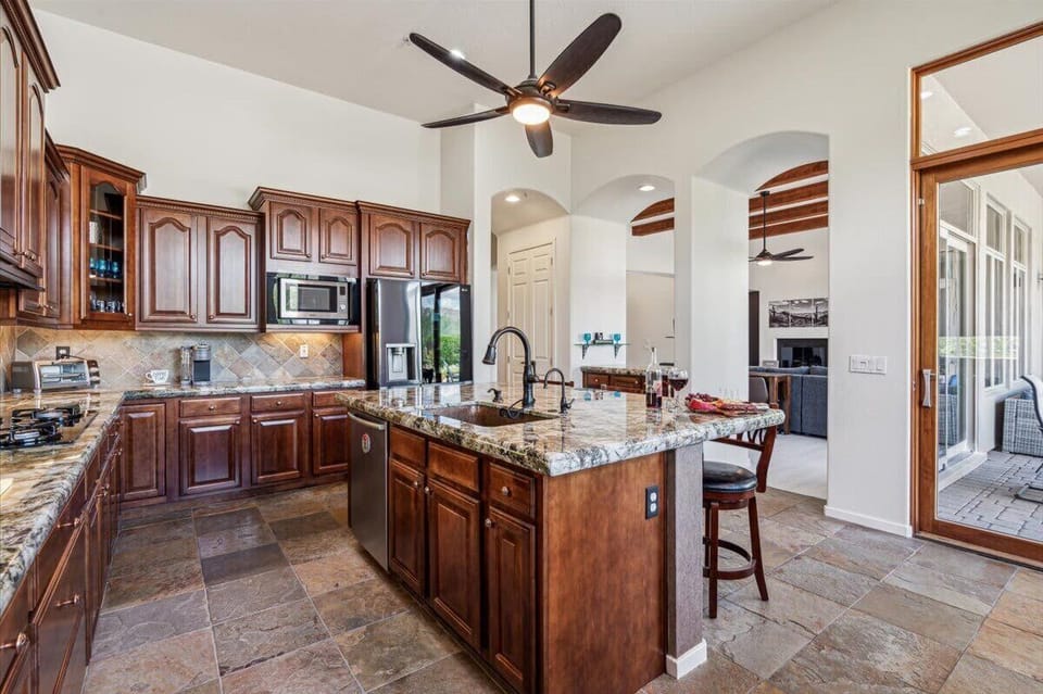 Stunning and fully equipped kitchen with speckled granite countertops and modern appliances.