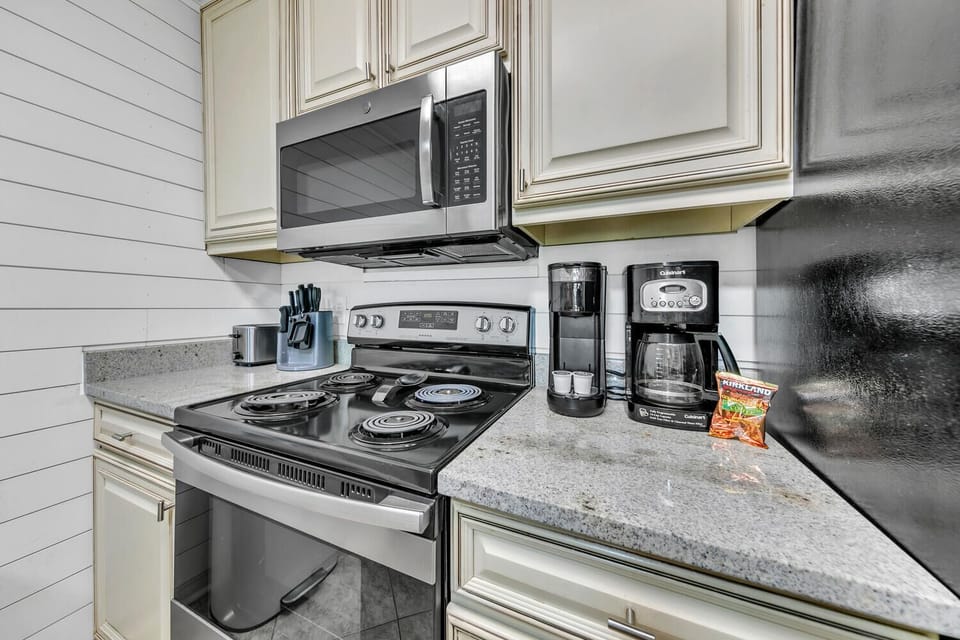 Cook your favorite meals in this fully equipped kitchen featuring granite counters, stainless steel appliances, and everything you need.