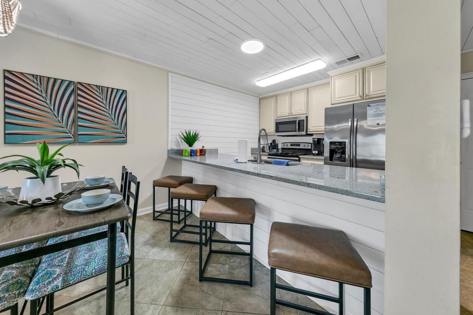 Your modern kitchen features granite countertops, stainless steel appliances, and a breakfast bar where you can enjoy coffee while planning your day.