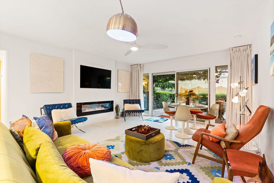 Living room features multiple seating and a Roku TV. 