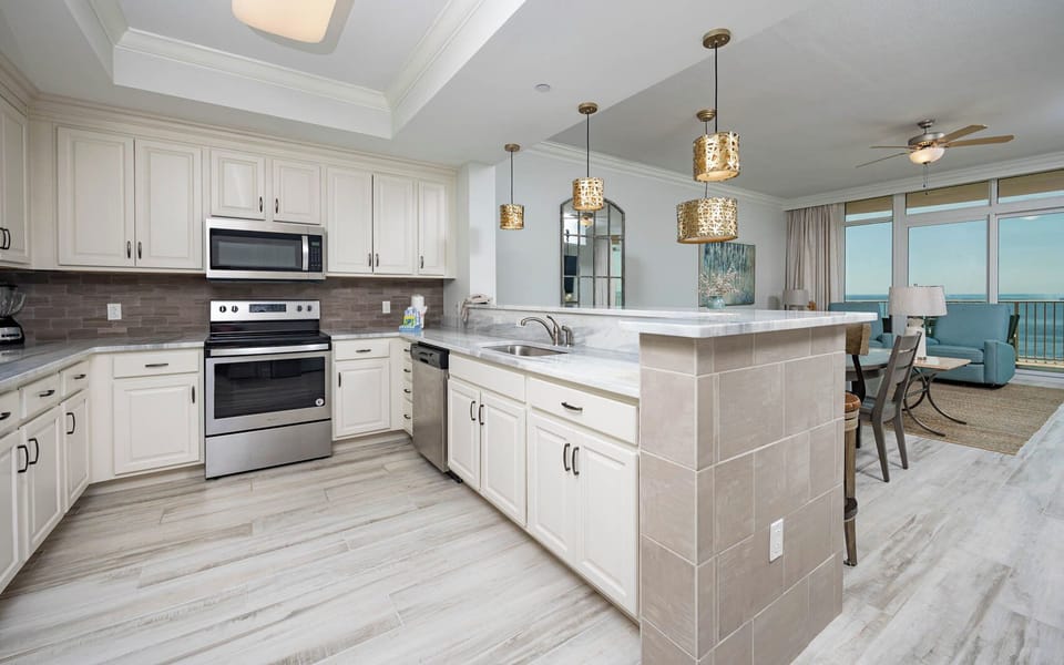Prepare meals in this kitchen with elegant cabinetry, stainless appliances, and stylish backsplash