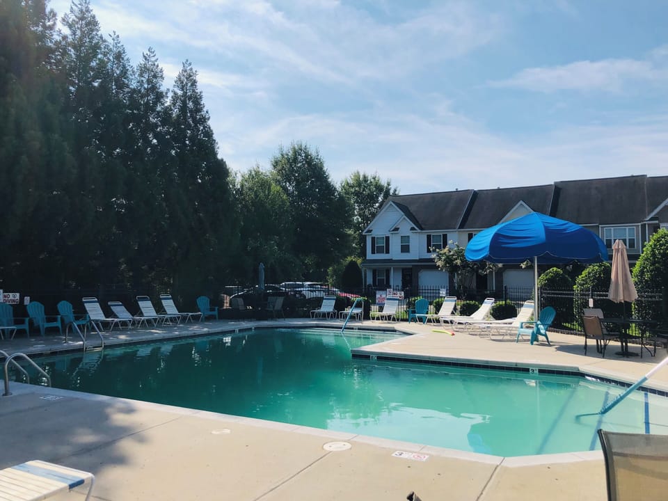 Enjoy a refreshing swim in the serene pool, surrounded by peaceful greenery.