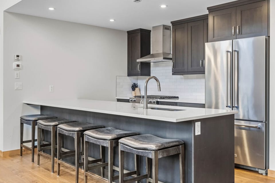 Beautiful modern kitchen, fully stocked for cooking and ample seating to entertain