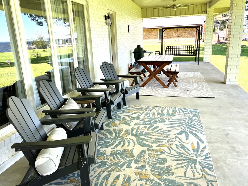 Back porch with plenty of seating. 
Large table for eating. 