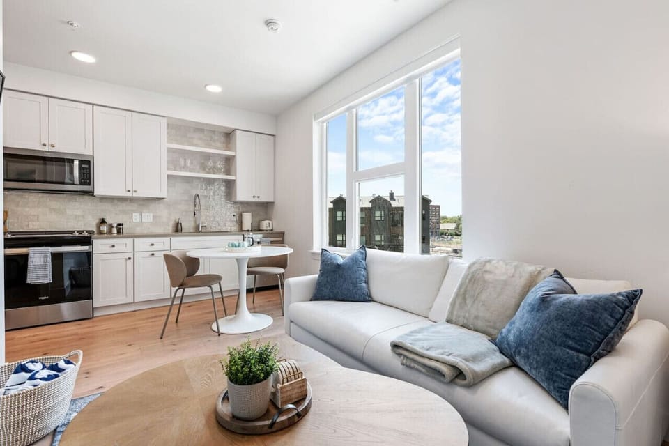 Beautifully designed living room. 65` TV, leather sofa and amazing views of mountains and city skyline.