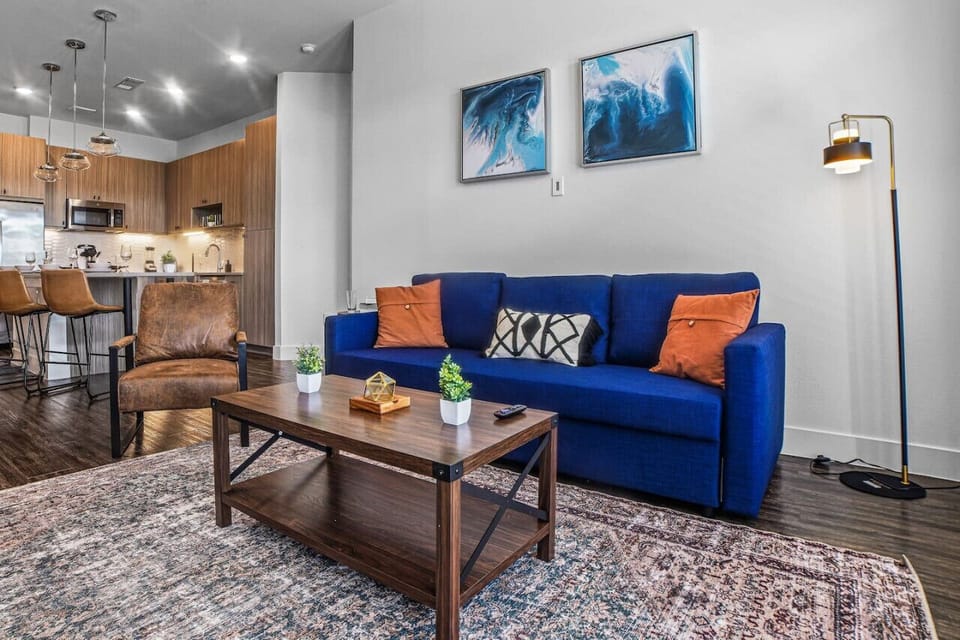 Bright and airy living room with plush seating, a large TV, and tasteful decor, creating the perfect space for relaxation and entertainment.