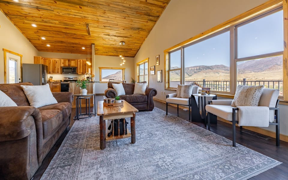 Our spacious living room is perfect for relaxing after a day of adventure, featuring large windows that let in plenty of natural light and breathtaking views.