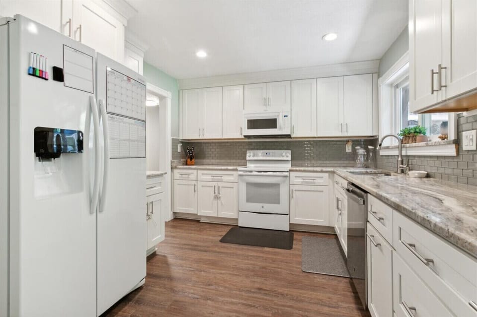 This kitchen has a refrigerator, microwave, stove, oven, dishwasher, and small appliances to make cooking a breeze.