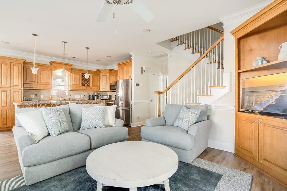 Cozy living room with open kitchen and natural wood accents