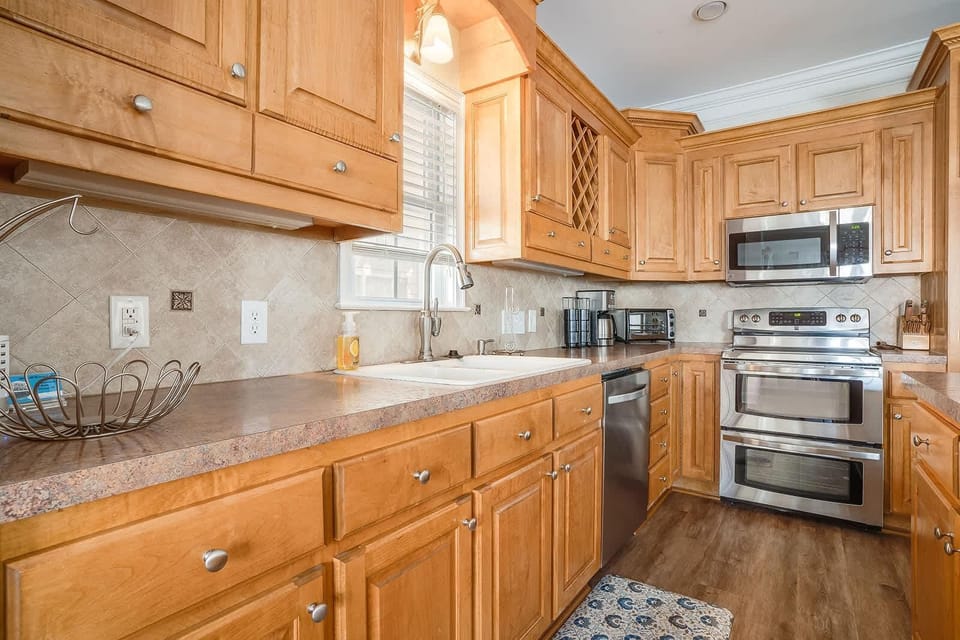 Spacious kitchen with warm wood cabinetry and modern appliances