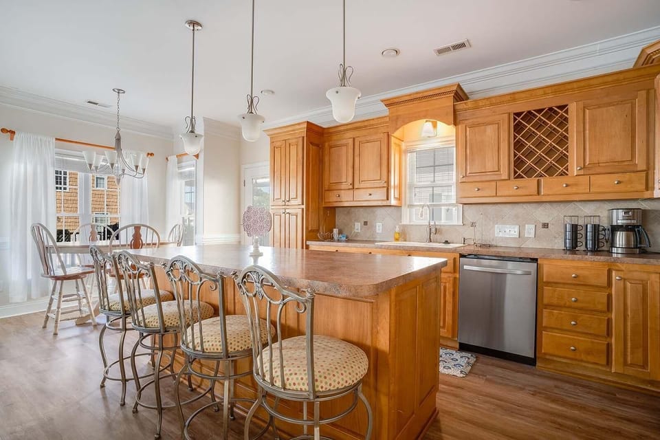 Sunlit kitchen with spacious island and cozy breakfast nook