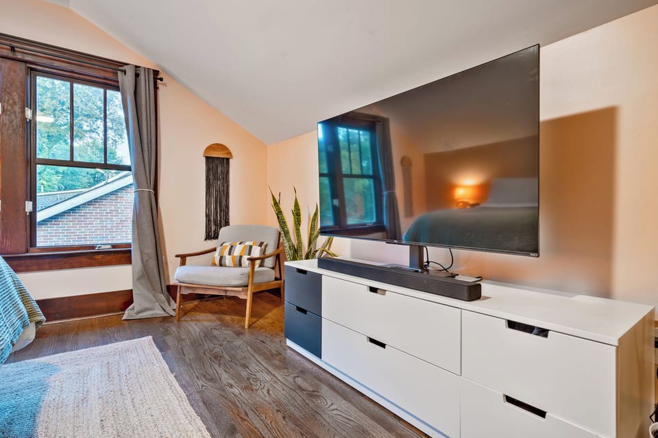 60 inch smart TV and tons of natural light in primary bedroom upstairs