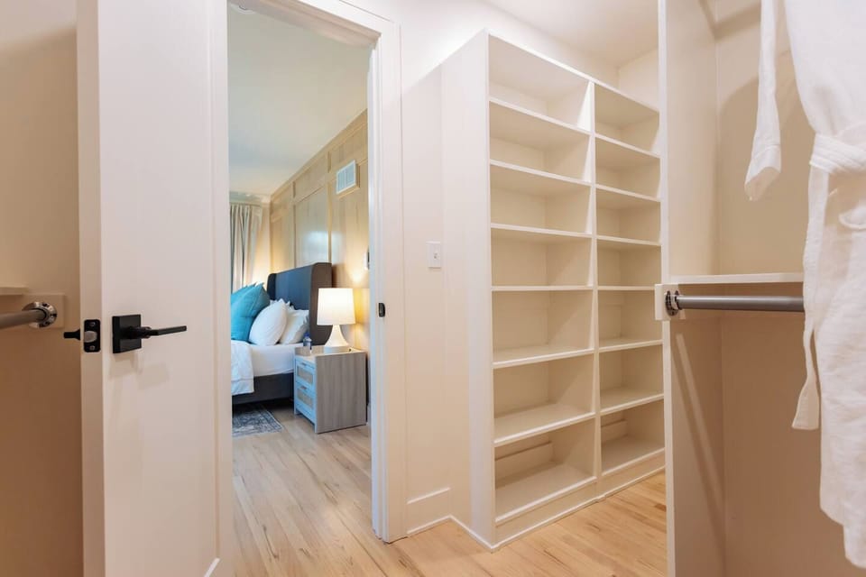 This spacious walk-in closet offers ample built-in shelving and hanging space, with a full length mirror just around the corner. Perfect for organizing your wardrobe and making yourself feel at home!