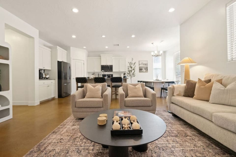 Large living room with oversized sectional and 2 swivel chairs