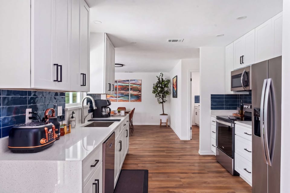 Prepare delicious meals in this stunning, fully equipped kitchen featuring sparkling quartz countertops and stainless steel appliances. With plenty of prep space and a thoughtful layout, it’s as functional as it is beautiful.