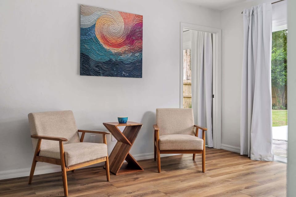 A closer look at the heart of the home. From the rich textures of the leather ottoman to the vibrant fiddle-leaf fig and curated art, every detail is chosen to provide a high-end, comfortable stay.