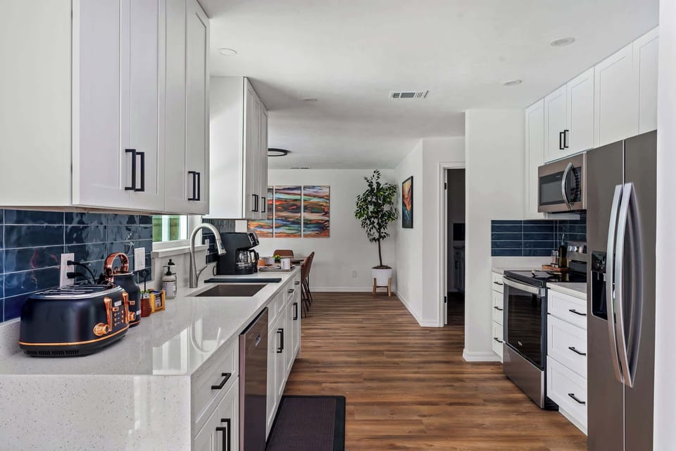 Prepare delicious meals in this stunning, fully equipped kitchen featuring sparkling quartz countertops and stainless steel appliances. With plenty of prep space and a thoughtful layout, it’s as functional as it is beautiful.