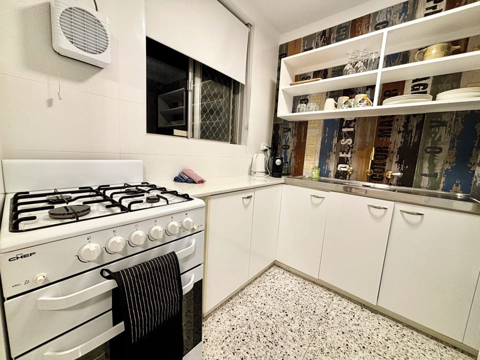 Full kitchen with gas stove and oven, microwave, fridge, kettle, toaster pots pans ...