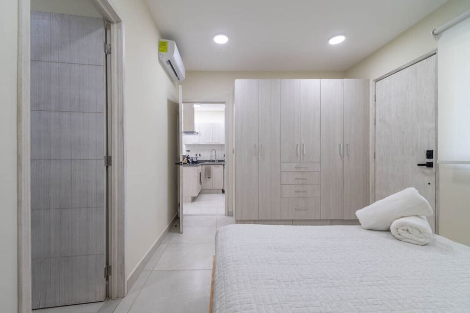 Rest and recharge in this serene bedroom with stylish decor and soft linens