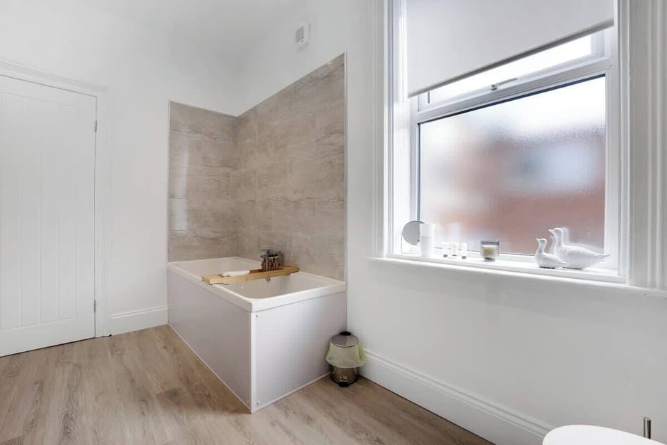 Enjoy a relaxing experience in the main bathroom, complete with a bath and overhead shower combination. It also includes a toilet and sink, offering all essential amenities to ensure comfort, convenience, and a refreshing daily routine.