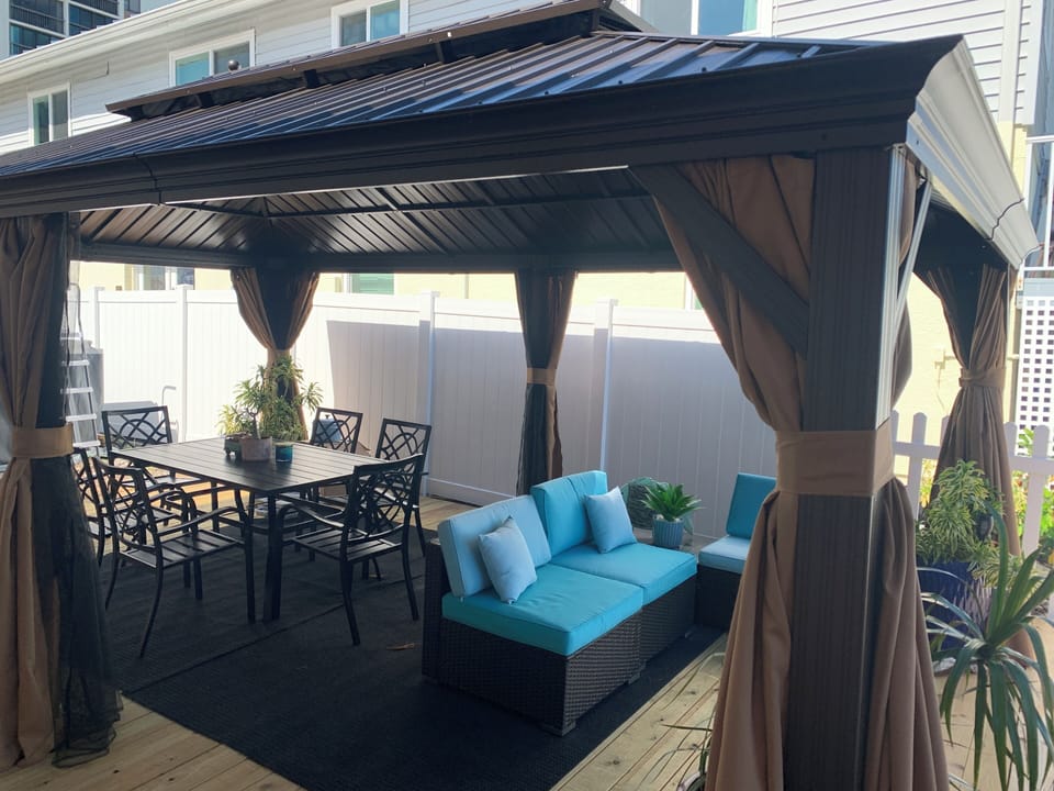 Gazebo view with lights and fan and dining room area for six