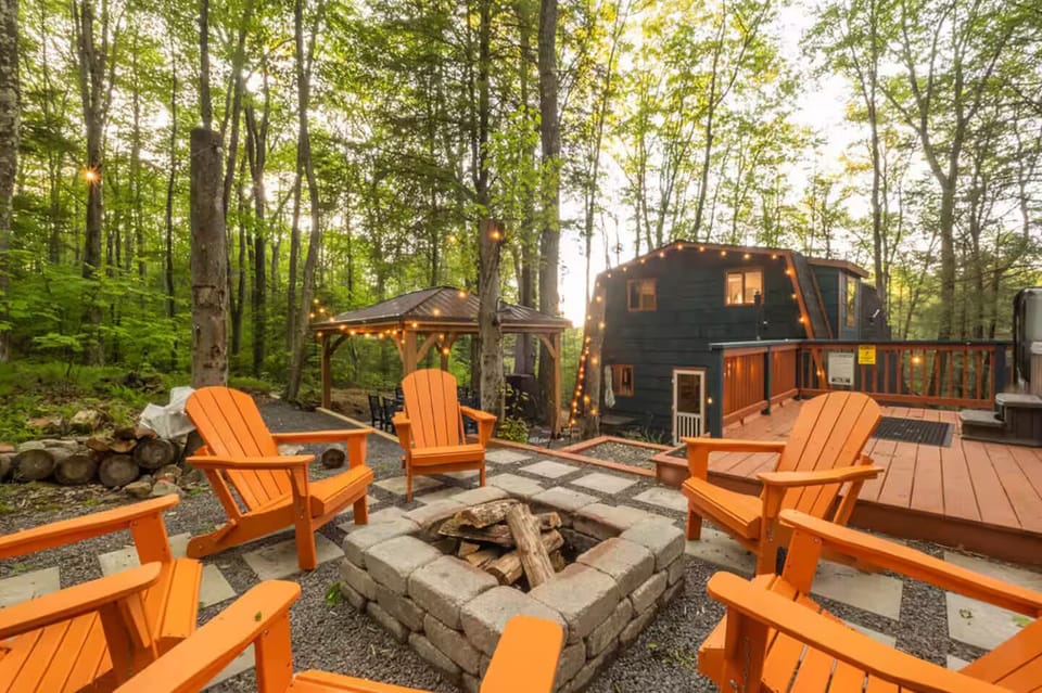 Enjoy nature by the fire pit, hot tub, in the sauna or under the covered pergola