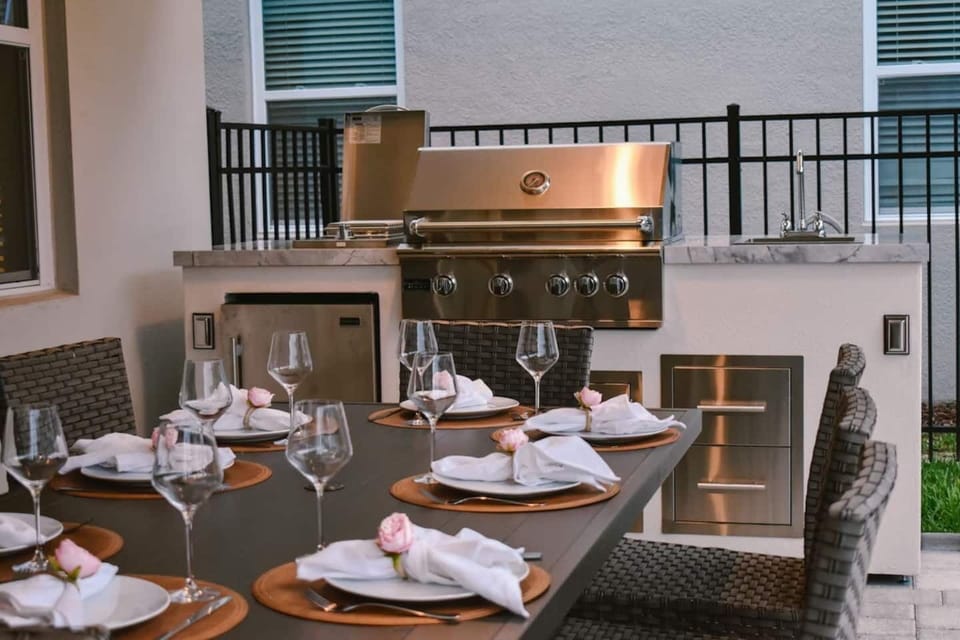 🍽️ Outdoor Chef’s Kitchen! Grill in style with a 32” pro-grade BBQ, side burner, beverage fridge & sink — fully equipped with all utensils for unforgettable alfresco dining.