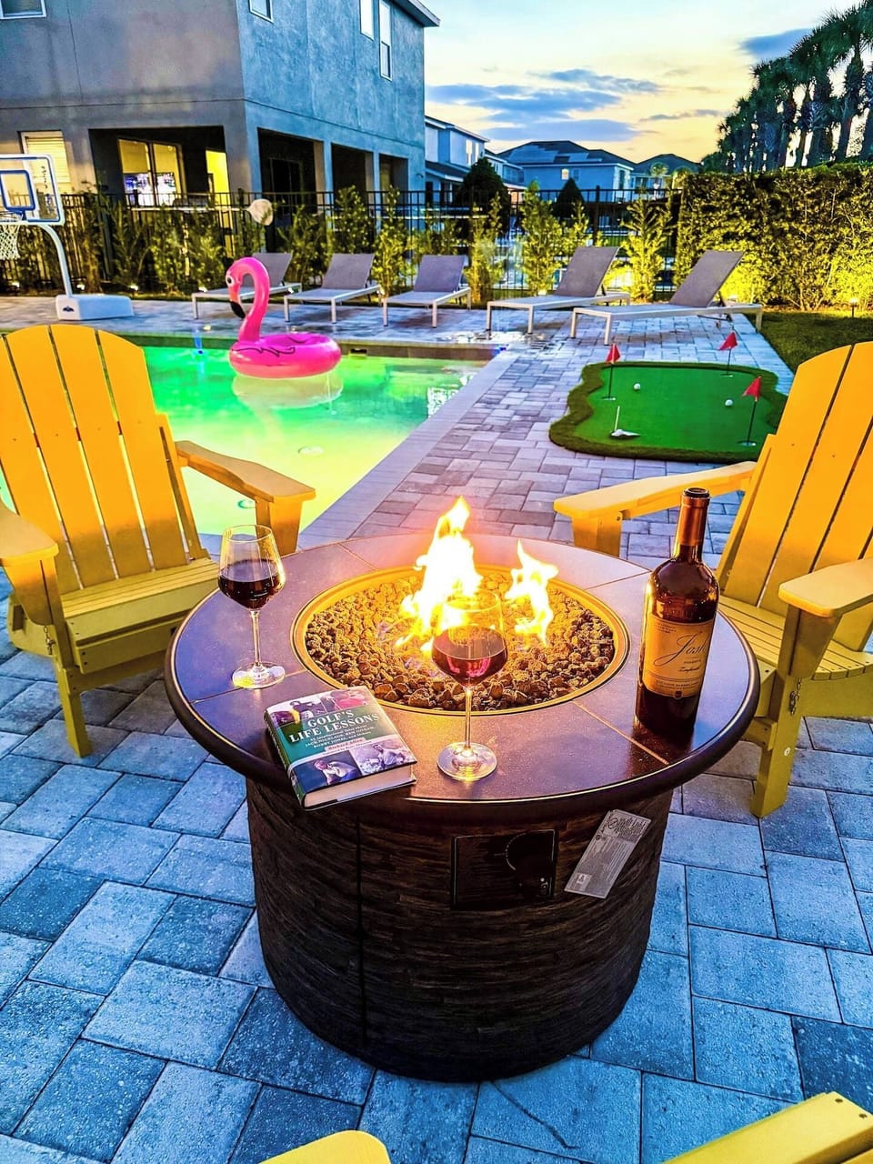 🔥 Evenings by the Fire Pit! Unwind with a glass of wine beside the glowing flames — surrounded by your private pool, spa, and mini-golf green for the perfect sunset vibe.