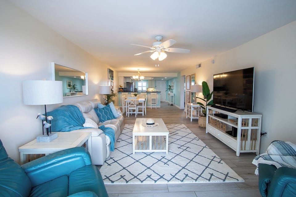 Bright and airy living space with plush seating and a modern entertainment setup.