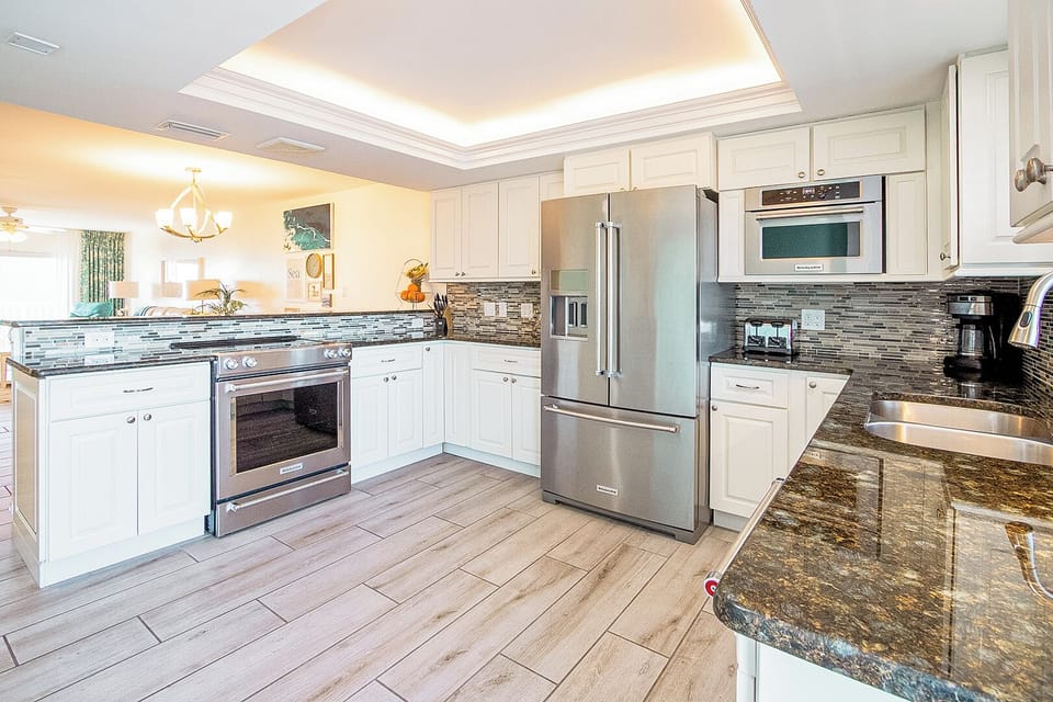 Modern kitchen with stainless steel appliances, sleek countertops, and custom cabinetry.
