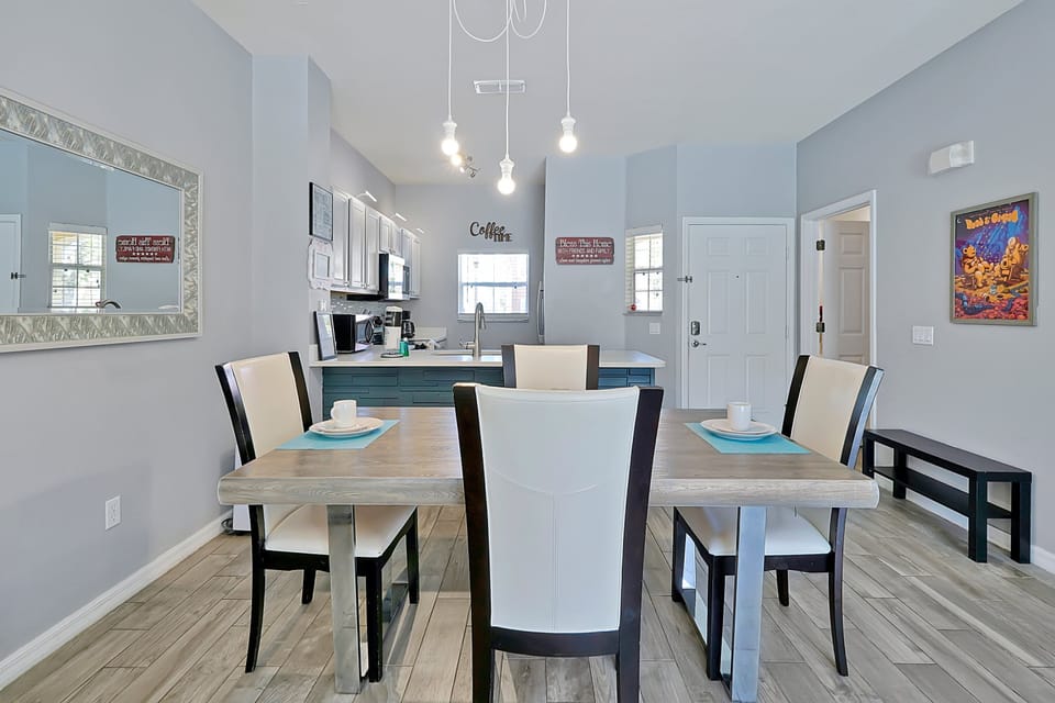 Seamless design. From the sleek kitchen bar to the large dining table, this central space is designed for both easy meal preparation and comfortable group seating.