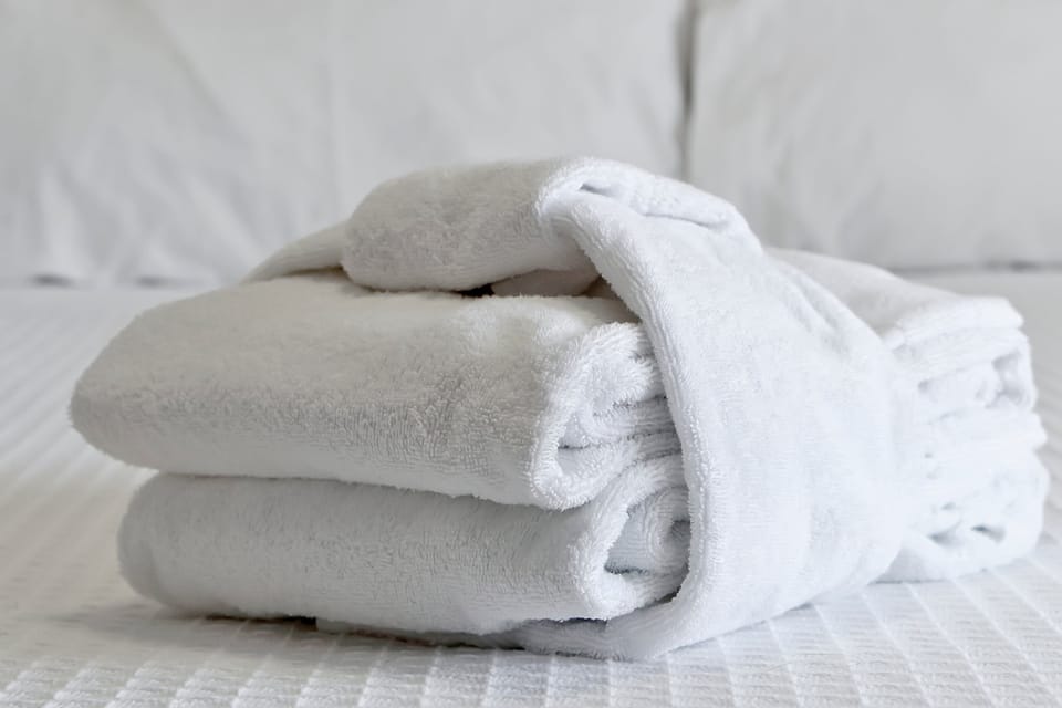 The softest details for your stay. Enjoy the comfort of fresh, premium towels and a cozy bathrobe provided for your ultimate relaxation.