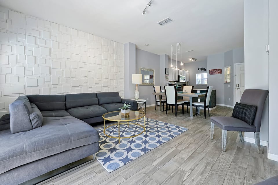 Modern and fully connected. This view showcases the fluid, open concept layout, perfect for family interaction between the living room, dining area, and kitchen.
