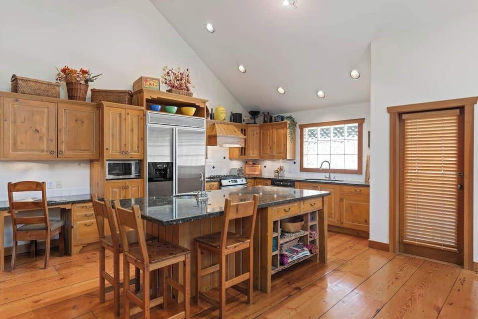- Spacious kitchen with granite island stainless appliances and warm wood finishes  
- Bright windows bring in mountain light for a cozy cooking space  
- Perfect for family breakfasts or evening meals together  

