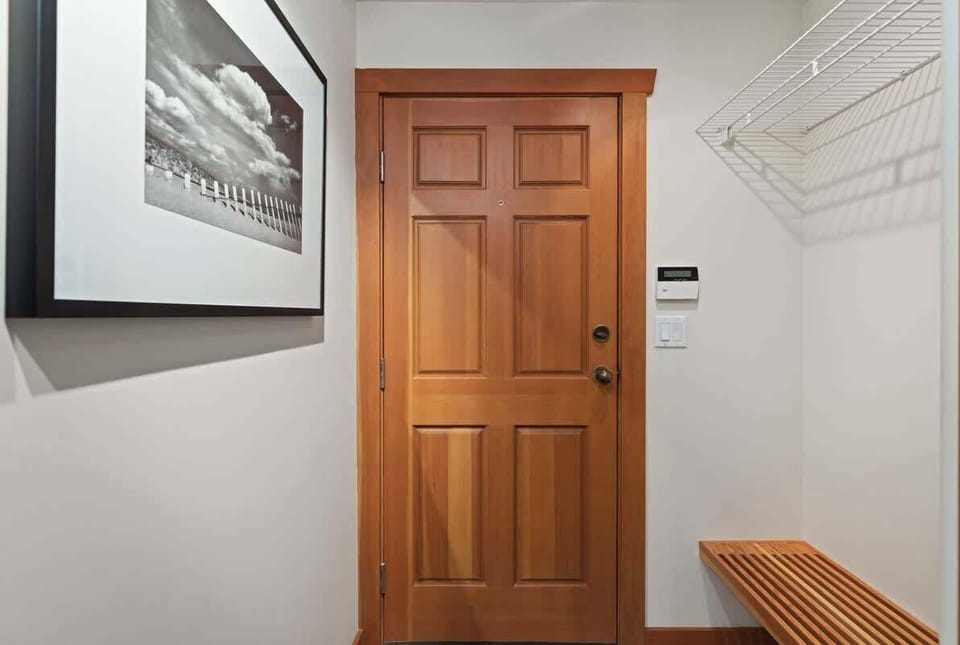 - Entryway with wood door and bench perfect for boots and gear  
- Organized coat rack adds convenience after outdoor adventures  
- Welcoming first impression of this warm mountain home  