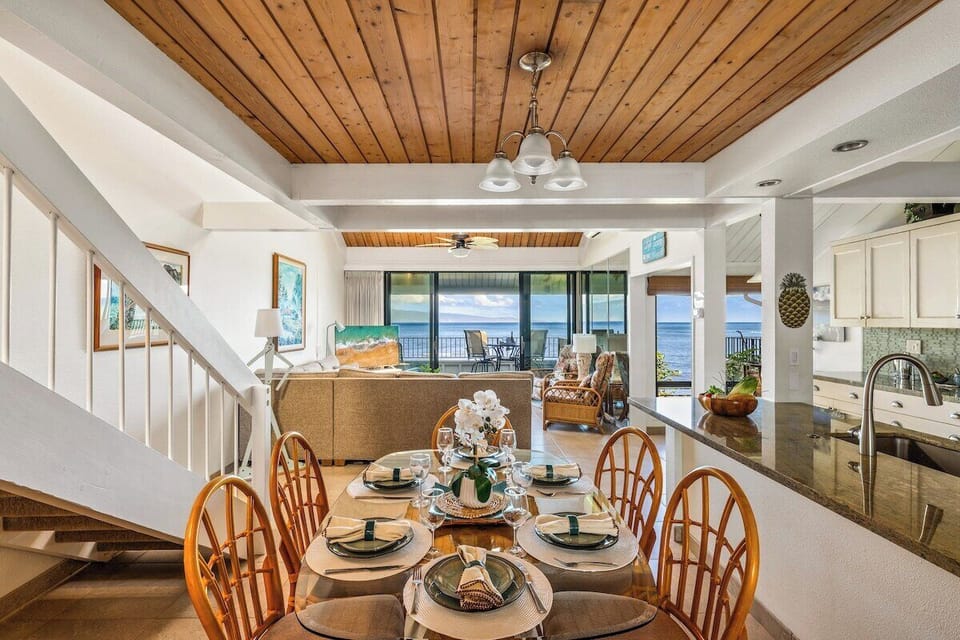 Enjoy meals in this bright dining area featuring tropical decor and a backdrop of blue waters