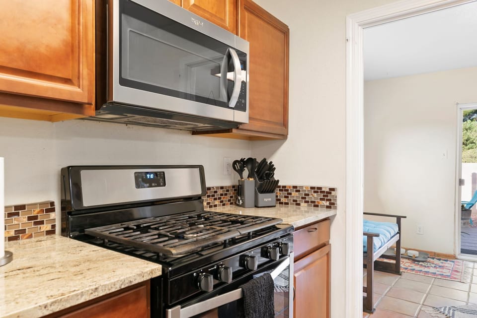 Full kitchen with stove, microwave, refrigerator and dishwasher
