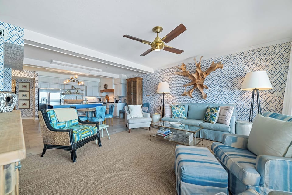 Subtle coastal touches and a neutral palette create a serene and relaxing ambiance in this open living and dining space.