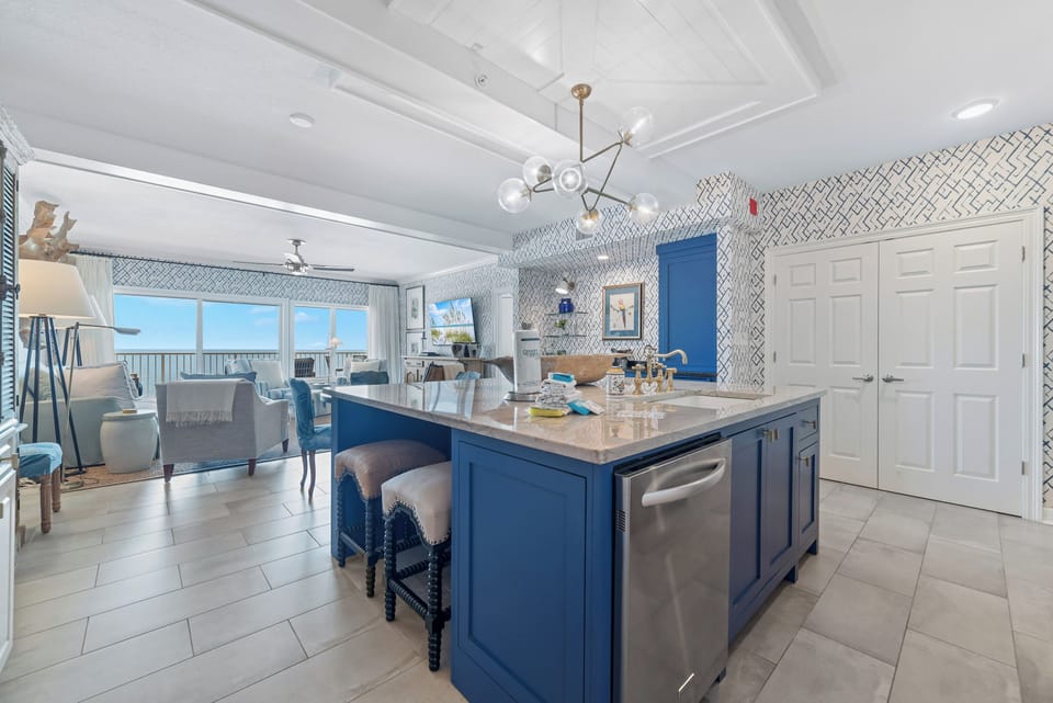 Sleek and sophisticated kitchen featuring a striking island with a stone countertop and comfortable bar stools.