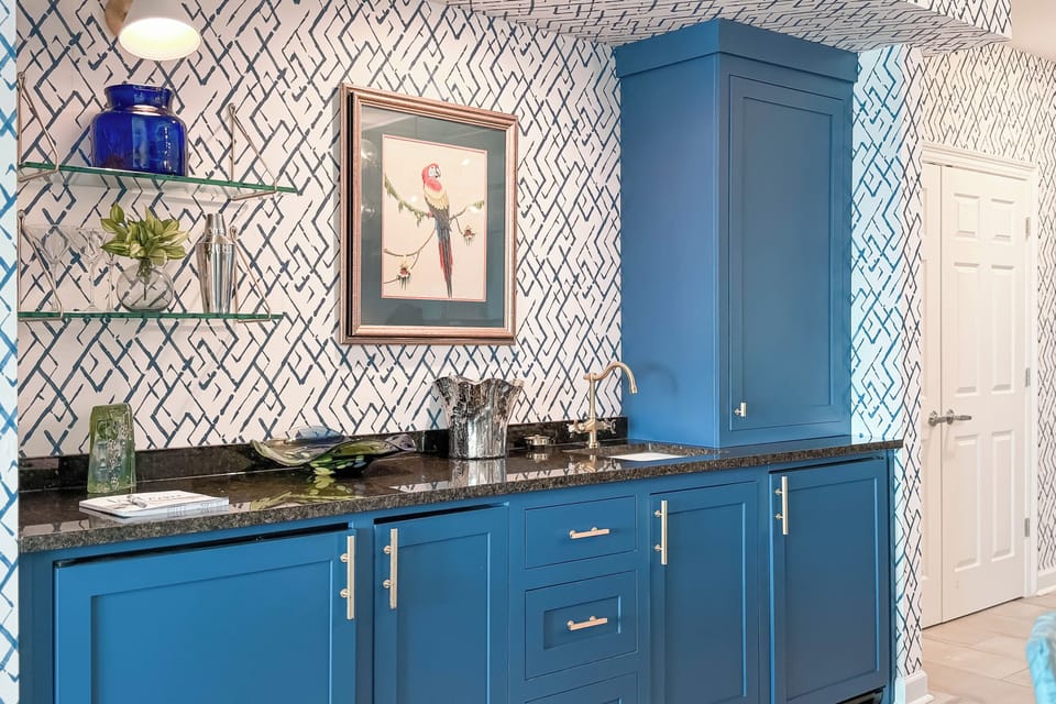 A thoughtfully designed wet bar seamlessly integrates into the living space, featuring elegant countertops and a chic vessel sink.