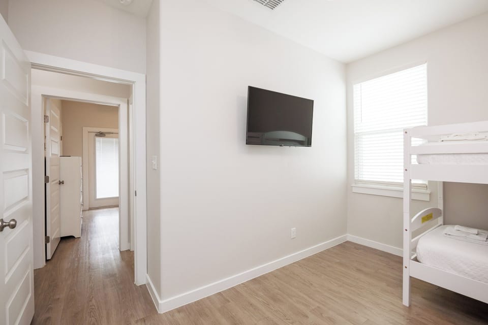 Your kids will love this bright bedroom with bunk beds and wall-mounted TV for movie nights and games.