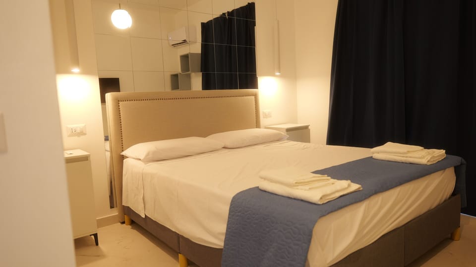 Luxury Suite, Balcony, City View | Down comforters, memory foam beds, desk, blackout drapes