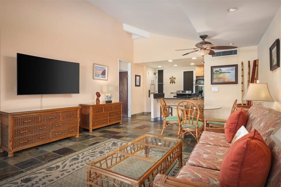 Unwind in your spacious living area where tropical charm meets modern comfort—perfect for gathering, streaming favorite shows, or simply relaxing after island adventures.