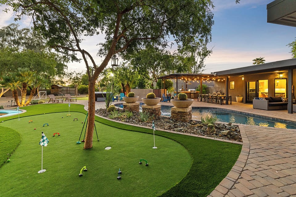 Putting green, shaded lounge & water features—perfect for poolside fun.