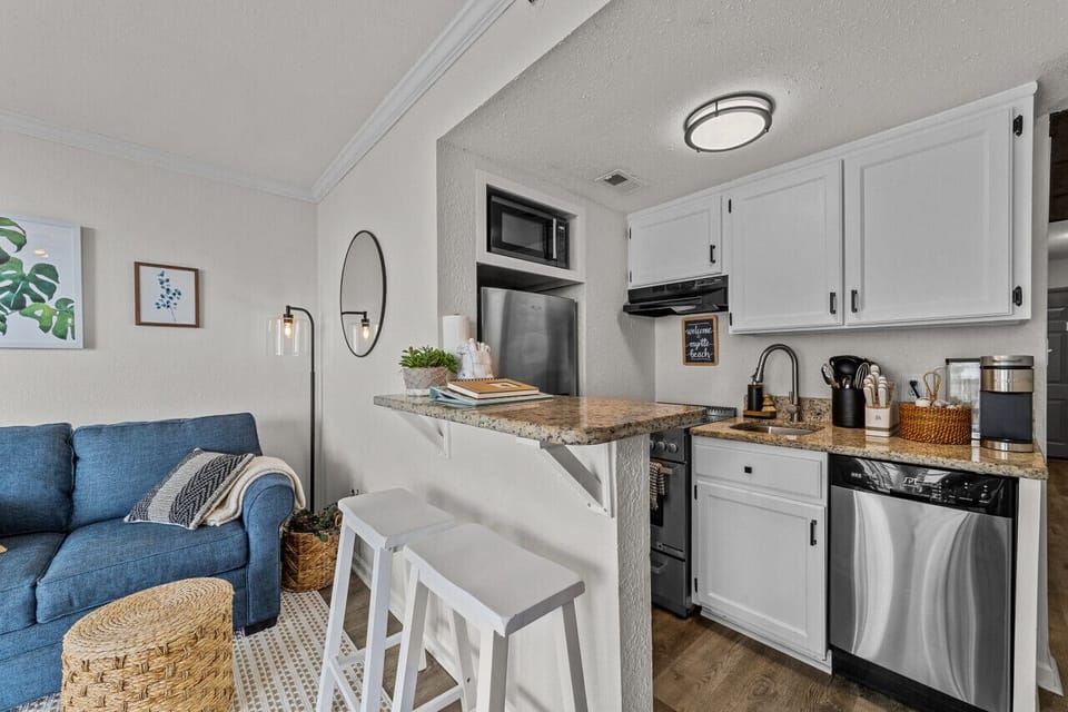 Bright, open, and perfect for gatherings! The living area flows right into the fully equipped kitchen.