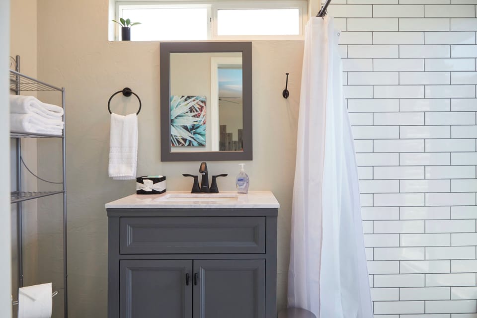 Tasteful second full bathroom with shower.