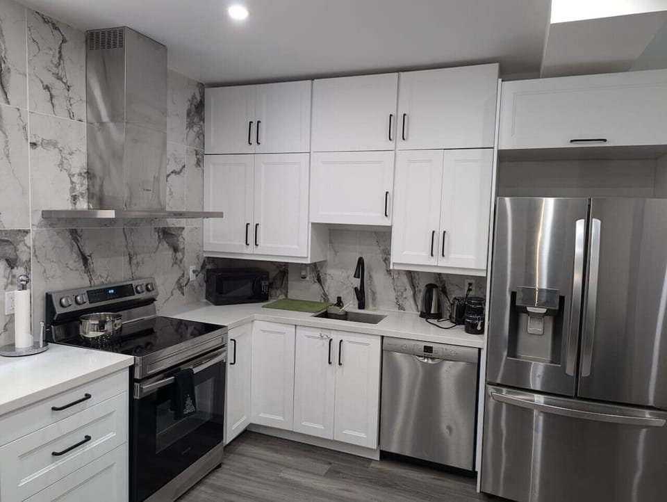 Sleek, modern kitchen with everything you need, including filtered water on tap! Whip up a culinary masterpiece with ease.  From stainless steel appliances to ample counter space, cooking here is a joy