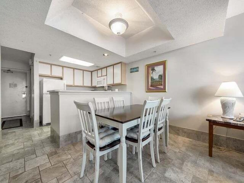 Dining Area - Dining table located beside the kitchen and living room, providing space for meals and gathering together.