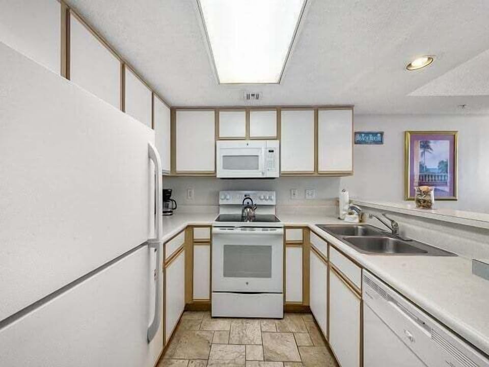 Dining Area - Kitchen with full appliances, cookware, and counter space for preparing meals during your stay.