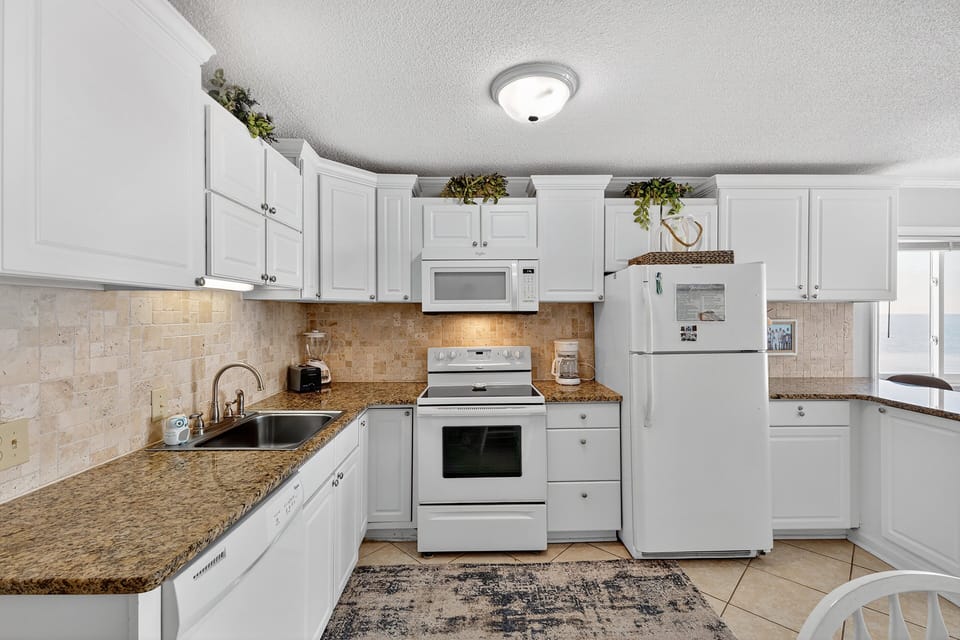 Kitchen - Modern kitchen featuring full-size appliances, breakfast bar seating, and plenty of room to prepare meals for your group.